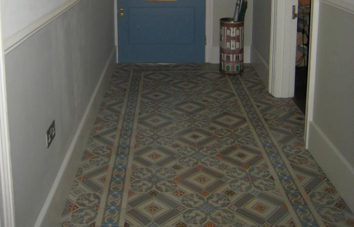 An antique octagon floor with cabochons in a north London hallway