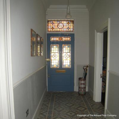 An antique octagon floor with cabochons in a north London hallway