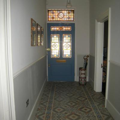 An antique octagon floor with cabochons in a north London hallway