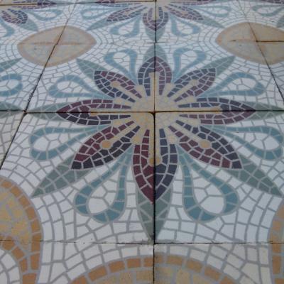 A c.15m2 mosaic themed ceramic floor with lush borders