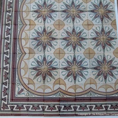 A c.15m2 mosaic themed ceramic floor with lush borders