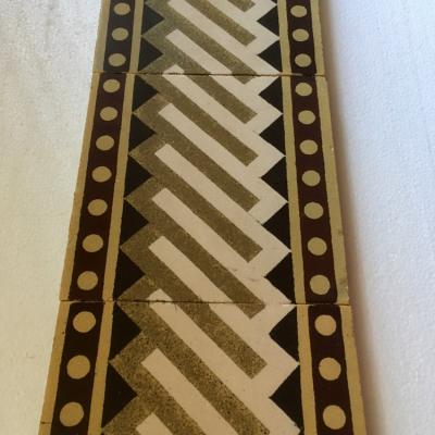 A run of antique French Sand & Cie border tiles