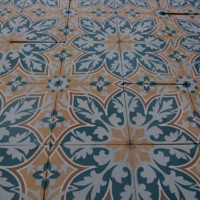 An 11.5m2+ vegetal themed antique French ceramic floor with triple borders