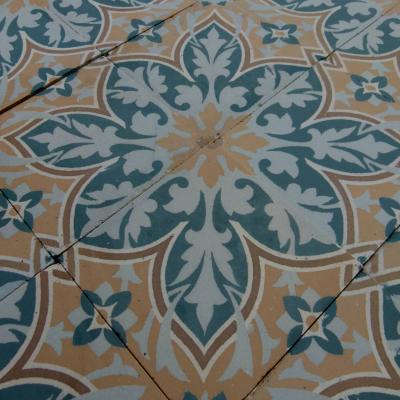 An 11.5m2+ vegetal themed antique French ceramic floor with triple borders