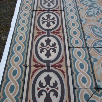 An 11.5m2+ vegetal themed antique French ceramic floor with triple borders