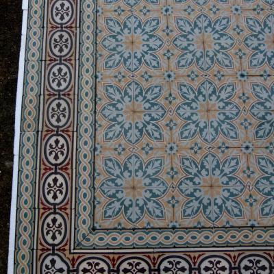 An 11.5m2+ vegetal themed antique French ceramic floor with triple borders