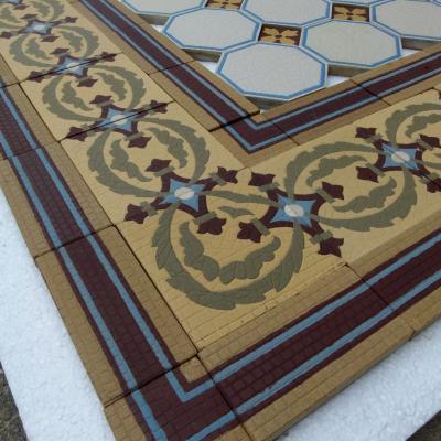 A handmade Boch Freres floor of octagon tiles with cabochons