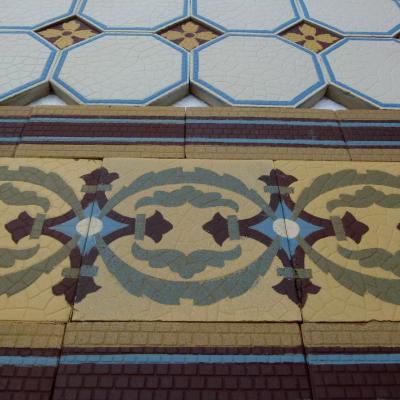 A handmade Boch Freres floor of octagon tiles with cabochons