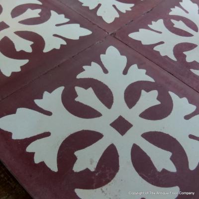 Four antique Carreaux de ciments tiles in bordeaux and white