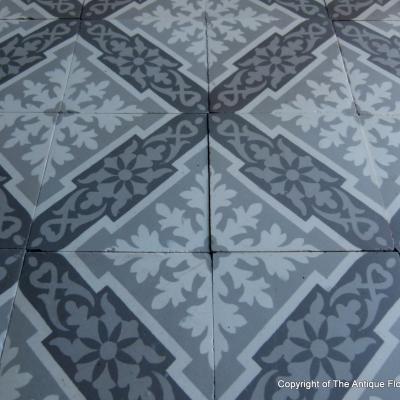 A panel of antique French ceramic encaustic tiles