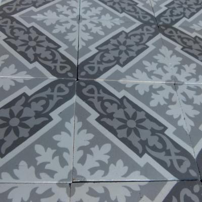 A panel of antique French ceramic encaustic tiles