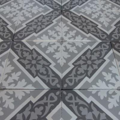 A panel of antique French ceramic encaustic tiles